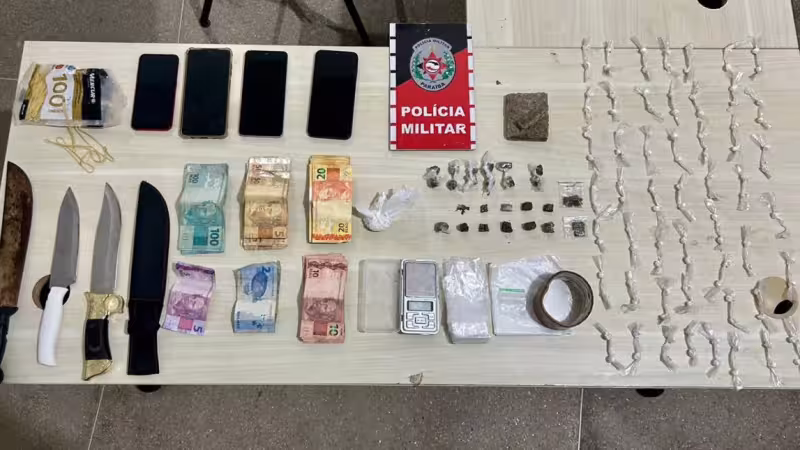 Maringá 98 FM — Três suspeitos de de trafico de drogas foram presos, na terça-feira (25), no bairro São Francisco, em Cajazeiras, no Sertão da Paraíba. Prisão ocorreu durante motopatrulhamento tático na região. De acordo com a Polícia Militar, a equipe recebeu denúncias de que os suspeitos estariam fracionando e embalando entorpecentes em uma área de mata. Conforme observou o ClickPB, foram apreendidos com os suspeitos, entorpecentes, dinheiro, celulares, facas, balança de precisão e materiais utilizados para acondicionamento das drogas. Dois homens foram presos e o terceiro foi localizado após diligências. Eles e todo o material foram conduzidos à Delegacia de Polícia Civil para as medidas cabíveis. &nbsp; &nbsp; [&hellip;]